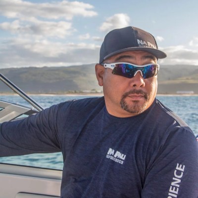 a man holding a fish in the water