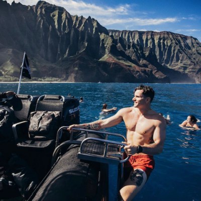 a person standing next to a body of water