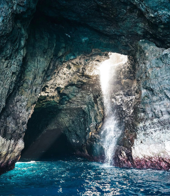a large waterfall over some water