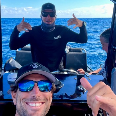 a man standing next to a body of water